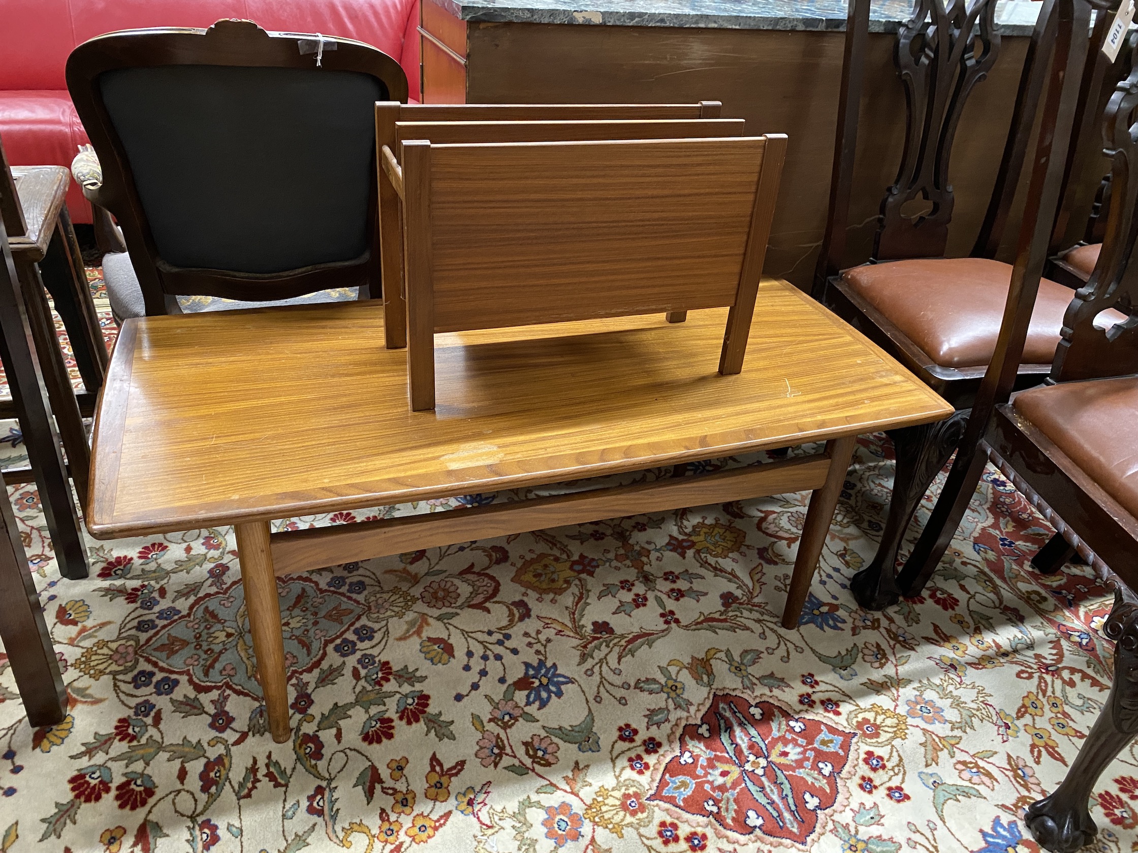 A mid century rectangular teak coffee table, length 118cm, depth 65cm, height 44cm together with a mid century teak magazine rack